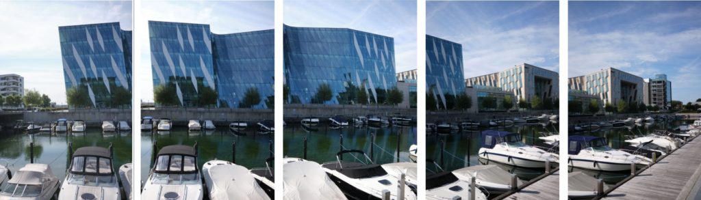 Five images used to create panoramic stitch of office building