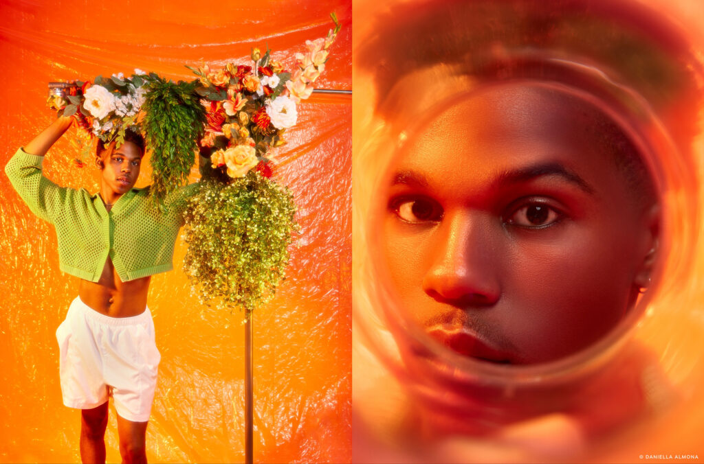 Daniella Almona loves using colorful lights, backdrops, props and clothes in her images. In the photo: Black model wearing a green cardigan and white shorts standing next to a floral installation