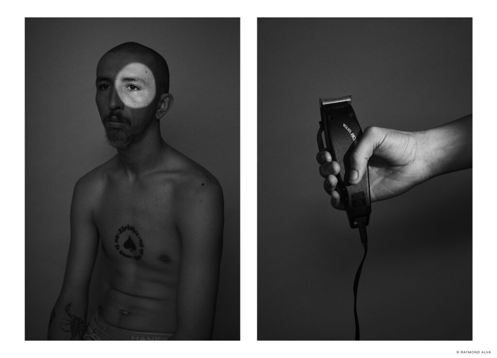 A shirtless man with a spotlight pointed at his right eye and a hand holding an electric razor. Shot by recently graduated photographer Raymond Alva.