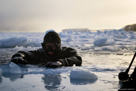 capture one raw image editor behind the scenes of a shoot/expedition diver with head and shoulders above surface of ice covered sea behind the scenes of a shoot/expedition diver with head and shoulders above surface of ice covered sea